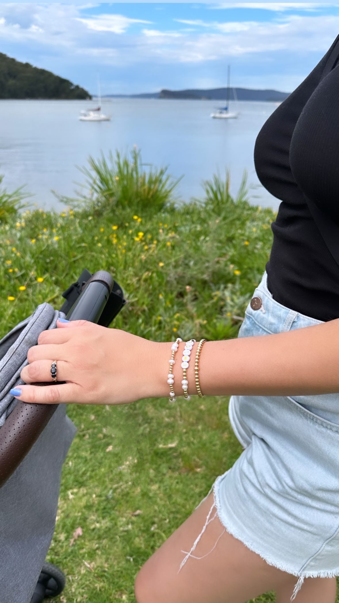 Woman pushing a pram wearing fashionable bracelets